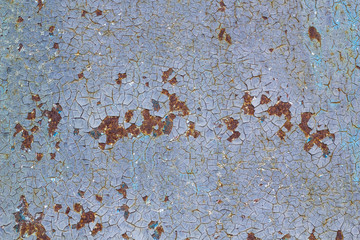 Rusted painted metal wall corrosion with streaks of rust