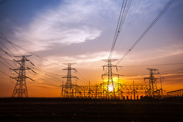 The silhouette of the evening electricity transmission pylon