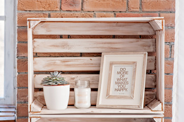 Bedroom decor elements in loft style: candles, coasters, succulents, pictures, photo frames