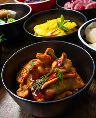 Set of different dumplings and ravioli on a wooden table