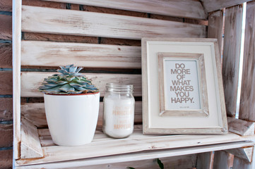 Bedroom decor elements in loft style: candles, coasters, succulents, pictures, photo frames