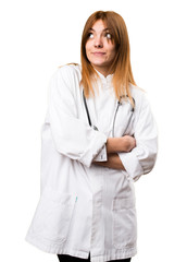 Fototapeta premium Young doctor woman making unimportant gesture