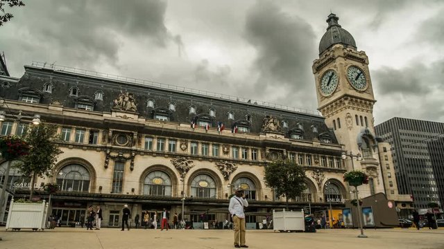 People walking across square in front of entrances to Lyon railway terminal