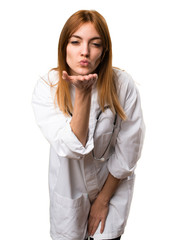 Young doctor woman sending a kiss