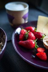 Porridge with strawberries close-up. Flakes are polly, oatmeal with strawberries. Cheese, bread  and  cappuccino   Healthy diet, diet, vitamins