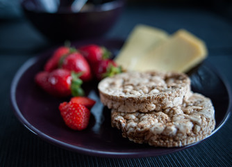Porridge with strawberries close-up. Flakes are polly, oatmeal with strawberries. Cheese, bread  and  cappuccino   Healthy diet, diet, vitamins