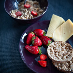 Porridge with strawberries close-up. Flakes are polly, oatmeal with strawberries. Cheese, bread  and  cappuccino   Healthy diet, diet, vitamins