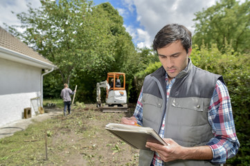 Foreman holding paper and pen