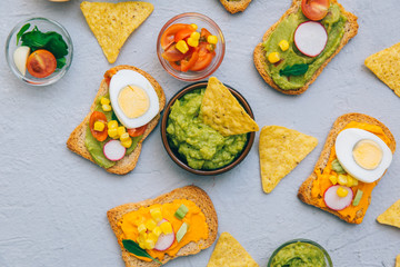 Healthy Eating, Diet sandwiches on gluten-free loaves - with guacamole, fresh vegetables on gray table, copy space