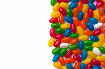 Brightly colored candy beans. Colourful jelly bean background. Jelly beans isolated on white background.