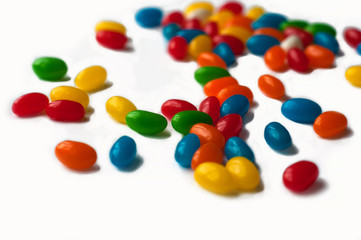 Brightly colored candy beans. Colourful jelly bean background. Jelly beans isolated on white background.