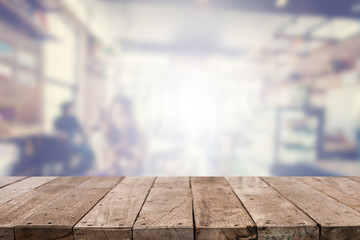 Wood table top with abstract blurred coffee shop background