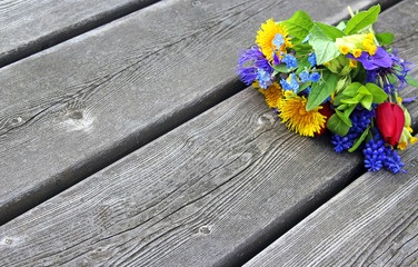bouquet of colorful spring flowers on wood planks
