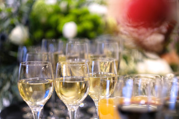 Glasses of wine and juice on a serving table at a buffet table