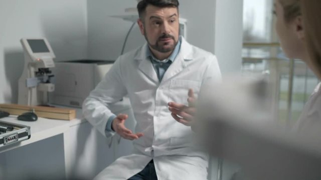 Chief optometrist consulting young doctor