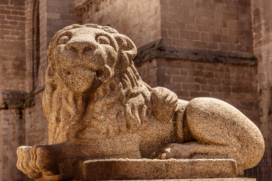 Lion sculpture in front of cathedral in Avila, Spain, toned