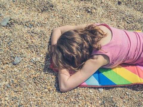Woman sleeping on beach in summer
