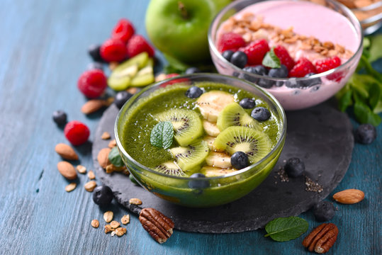 Smoothie bowl, pink and green smoothie with berries, healthy breakfast, vegan vitamin snack
