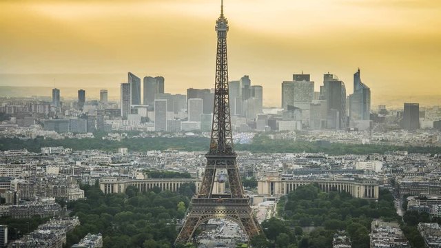 Eiffel Tower in Paris, modern business centers at back, urban life time-lapse