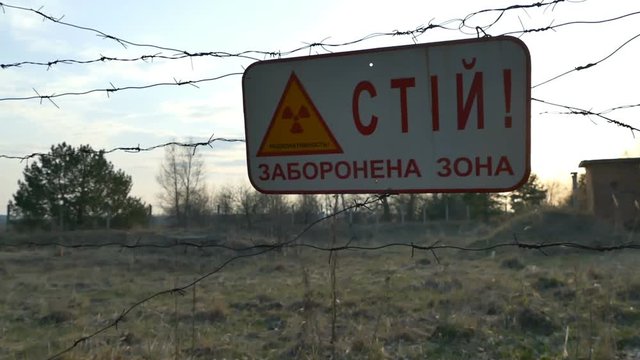 Stop sign, radioactive zone. The sign hangs on the barbed wire.Chernobyl,Ukraine