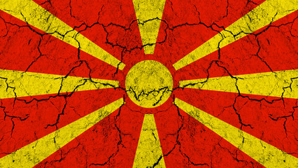Flag of Macedonia on rugged wall full of scratches - metaphor of problem and crisis leading to collapse of Macedonian country 