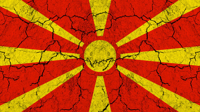 Flag of Macedonia on rugged wall full of scratches - metaphor of problem and crisis leading to collapse of Macedonian country 