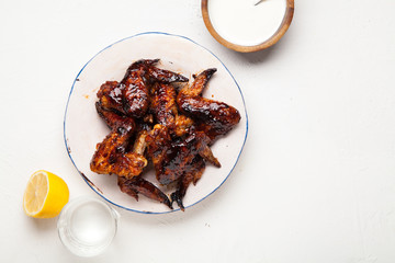 Chicken wings with two sauces on white background. Summer barbeque concept.