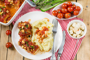 Fish cod baked in tomato sauce with feta cheese