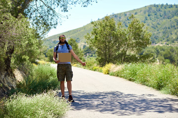 Hitch-hiking traveler with a blank cardboard sign