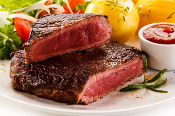 Grilled beefsteak with potatoes on white background