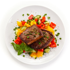 Grilled beefsteak with vegetables on white background