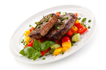 Grilled beefsteak with vegetables on white background