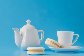 macaroons with coffee cup on the blue paper background