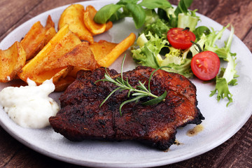 Grilled steaks, baked potatoes and salad