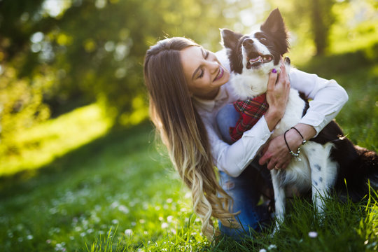 Beautiful Woman Walking Cute Dog In Nature