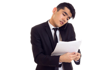 Young man in suit holding papers