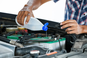 Cropped image of automobile mechanic repairing car in store, day time