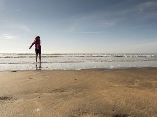 Fototapeta na wymiar Girl with her feet in water.
