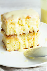 Lemon cupcake on a white plate close-up.