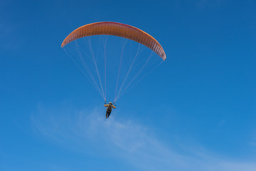Parachutist over sky background