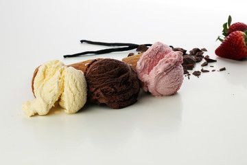 three scoops of ice cream - vanilla, strawberry and chocolate