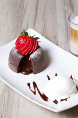 Chocolate fondant lava cake with strawberries and ice cream