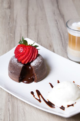 Chocolate fondant lava cake with strawberries and ice cream