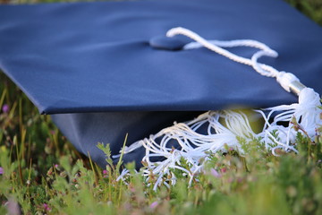 Close up of graduation cap on grassy field