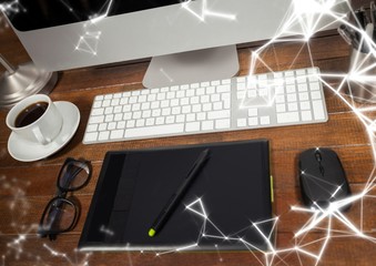 Graphics tablet in front of computer with white network overlay
