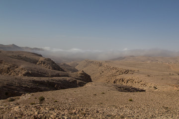 Mist crawling up a canyon in the Salma plateau in the Sultanate of Oman
