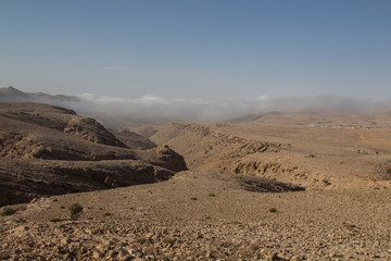 Mist crawling up a canyon in the Salma plateau in the Sultanate of Oman