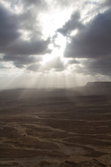 The sun breaks through the clouds at a wadi in the Sultanate of Oman