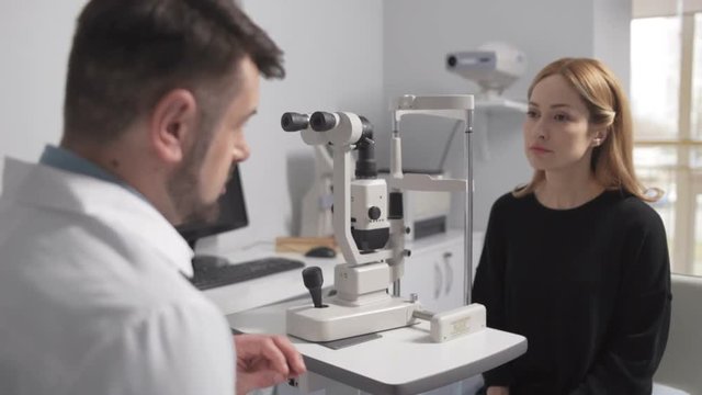 Male optometrist on consultation with patient