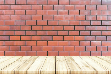 Empty wooden table top with red brick wall texture background.